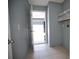 This laundry room has tiled floors and shelving at 7700 Greytwig Ln, Orlando, FL 32818