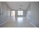 Spacious and bright living area with tile floors and a large front window, perfect for entertaining at 7700 Greytwig Ln, Orlando, FL 32818