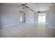 Bright, open-concept living room with tile flooring and sliding glass doors leading to the lanai at 7700 Greytwig Ln, Orlando, FL 32818