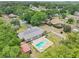 A beautiful in-ground pool and spa combination sit nestled in the back yard of this single Gathering home in an aerial view at 7779 Lake Andrea Cir, Mount Dora, FL 32757