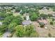 This aerial shot shows the home's inviting pool, established landscaping, and its location on a tranquil, tree-lined street at 7779 Lake Andrea Cir, Mount Dora, FL 32757