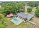 Aerial view of a backyard oasis with a kidney-shaped pool, and a cozy gazebo next to a single-Gathering home at 7779 Lake Andrea Cir, Mount Dora, FL 32757