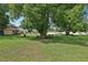 Expansive backyard with mature trees, shed and outdoor seating area, ideal for relaxation at 7779 Lake Andrea Cir, Mount Dora, FL 32757