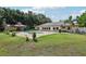 Backyard featuring a shed with a red roof, pool, and manicured lawn, creating an inviting outdoor space at 7779 Lake Andrea Cir, Mount Dora, FL 32757