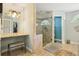 Charming bathroom featuring a glass shower, vanity area, and unique tiled floors at 7779 Lake Andrea Cir, Mount Dora, FL 32757