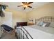 Neutral bedroom with ceiling fan, dresser, and a comfortable-looking bed at 7779 Lake Andrea Cir, Mount Dora, FL 32757