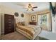 Relaxing bedroom with neutral tones, a decorative headboard, and a bright window at 7779 Lake Andrea Cir, Mount Dora, FL 32757
