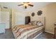 Cozy bedroom featuring a ceiling fan, closet, decorative accents, and carpet at 7779 Lake Andrea Cir, Mount Dora, FL 32757