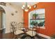 Bright dining area with an aquarium window, chandelier, and hardwood floors at 7779 Lake Andrea Cir, Mount Dora, FL 32757