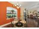 Bright dining area with an aquarium window, chandelier, and hardwood floors at 7779 Lake Andrea Cir, Mount Dora, FL 32757