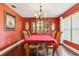 Formal dining room featuring a wooden china cabinet, chandelier, and hardwood floors at 7779 Lake Andrea Cir, Mount Dora, FL 32757