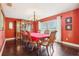 Formal dining room featuring a wooden china cabinet, chandelier, and hardwood floors at 7779 Lake Andrea Cir, Mount Dora, FL 32757
