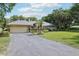Single-Gathering home with an attached two-car garage and manicured front yard at 7779 Lake Andrea Cir, Mount Dora, FL 32757