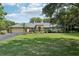 Charming single Gathering home with a lush green lawn and beautifully landscaped front yard at 7779 Lake Andrea Cir, Mount Dora, FL 32757