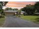 Charming single Gathering home with a lush green lawn and beautifully landscaped front yard at 7779 Lake Andrea Cir, Mount Dora, FL 32757