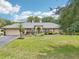 Charming single-story home featuring a well-manicured lawn and professional landscaping at 7779 Lake Andrea Cir, Mount Dora, FL 32757