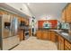 Open kitchen with stainless steel appliances, tiled floors, and ample cabinets at 7779 Lake Andrea Cir, Mount Dora, FL 32757