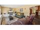 Comfortable living room featuring hardwood floors, a plush sofa, and entertainment center at 7779 Lake Andrea Cir, Mount Dora, FL 32757