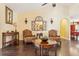 Cozy living room with hardwood floors, two chairs, decor, and neutral-colored walls at 7779 Lake Andrea Cir, Mount Dora, FL 32757