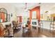 Spacious living room with fireplace, dark hardwood floors and orange accent wall at 7779 Lake Andrea Cir, Mount Dora, FL 32757