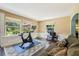 Inviting living room with hardwood floors and natural light coming through the windows at 7779 Lake Andrea Cir, Mount Dora, FL 32757