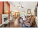 Bright living room with fireplace, dark floors, and an open-concept design at 7779 Lake Andrea Cir, Mount Dora, FL 32757
