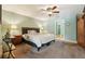 Spacious main bedroom with carpet floors, ceiling fan, and natural light from doorway at 7779 Lake Andrea Cir, Mount Dora, FL 32757
