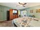 Spacious main bedroom with carpet floors, ceiling fan, and natural light from doorway at 7779 Lake Andrea Cir, Mount Dora, FL 32757