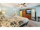 Spacious main bedroom with carpet floors, ceiling fan, and natural light from doorway at 7779 Lake Andrea Cir, Mount Dora, FL 32757