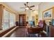 Spacious home office with a built-in bookcase, large window and hardwood flooring at 7779 Lake Andrea Cir, Mount Dora, FL 32757