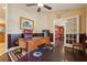 Comfortable home office with a dark wood desk, leather chair, and hardwood flooring at 7779 Lake Andrea Cir, Mount Dora, FL 32757