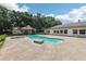 Inviting backyard featuring a pool, spa, and a cabana perfect for outdoor relaxation and entertaining at 7779 Lake Andrea Cir, Mount Dora, FL 32757