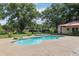 Beautiful pool area with a spa, lush landscaping, and a cabana, creating a serene outdoor retreat at 7779 Lake Andrea Cir, Mount Dora, FL 32757