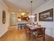 Dining area with wood floors open to kitchen featuring seating for six at 8000 Tuscany Way # 4408, Davenport, FL 33896