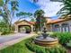 Exterior drive-through entrance to the clubhouse with a large water fountain feature at 8000 Tuscany Way # 4408, Davenport, FL 33896