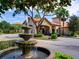 Exterior drive-through entrance to the clubhouse with a large water fountain feature at 8000 Tuscany Way # 4408, Davenport, FL 33896