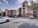 Exterior view of condo building featuring multiple levels and ample parking at 8000 Tuscany Way # 4408, Davenport, FL 33896