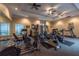 Community gym with a variety of fitness equipment, mirrored walls, and ceiling fans at 8000 Tuscany Way # 4408, Davenport, FL 33896
