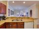 Kitchen view looking out to dining and living spaces, granite counters, and stainless sink at 8000 Tuscany Way # 4408, Davenport, FL 33896