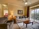 Relaxing living room with a view from the balcony, comfortable seating, and neutral decor at 8000 Tuscany Way # 4408, Davenport, FL 33896