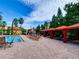 Expansive pool area offering cabanas, lounge chairs, and tropical landscaping under a sunny sky at 8000 Tuscany Way # 4408, Davenport, FL 33896