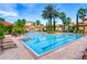 Large community pool with clear water, surrounded by palm trees and Mediterranean-style buildings at 8000 Tuscany Way # 4408, Davenport, FL 33896
