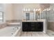 Bathroom featuring a soaking tub, double vanity, tiled accent wall, and glass enclosed shower at 8058 Corkfield Ave, Orlando, FL 32832
