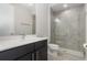 Modern bathroom features a glass enclosed tiled shower, large mirror, and vanity with storage at 8058 Corkfield Ave, Orlando, FL 32832