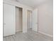 Bright bedroom features light gray wood-look floors and a large closet with sliding doors at 8058 Corkfield Ave, Orlando, FL 32832