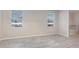 Bright bedroom with plank flooring, and two windows letting in natural light at 8058 Corkfield Ave, Orlando, FL 32832
