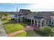 Clubhouse exterior featuring a brick pathway, manicured lawn, and inviting architectural details at 8058 Corkfield Ave, Orlando, FL 32832