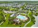 Aerial view of community pool area with ample seating, a clubhouse, and lush landscaping at 8058 Corkfield Ave, Orlando, FL 32832