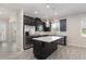Modern kitchen with stainless steel appliances, dark cabinetry, and a center island at 8058 Corkfield Ave, Orlando, FL 32832