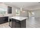 Stylish kitchen island with white countertop, storage, and open layout to the living area at 8058 Corkfield Ave, Orlando, FL 32832